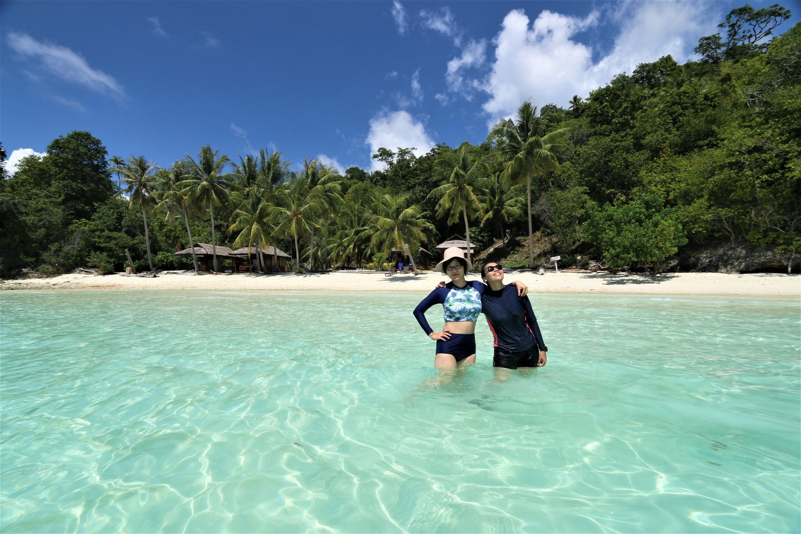 swimming at white sandy beach at Togean Islands tour package